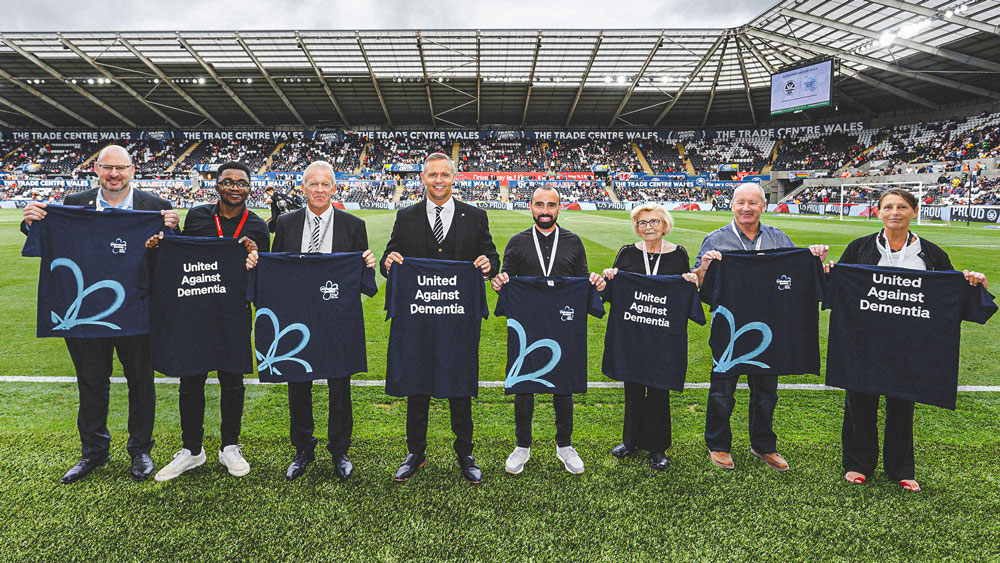 The FPA holding up United Against Dementia t-shirts 