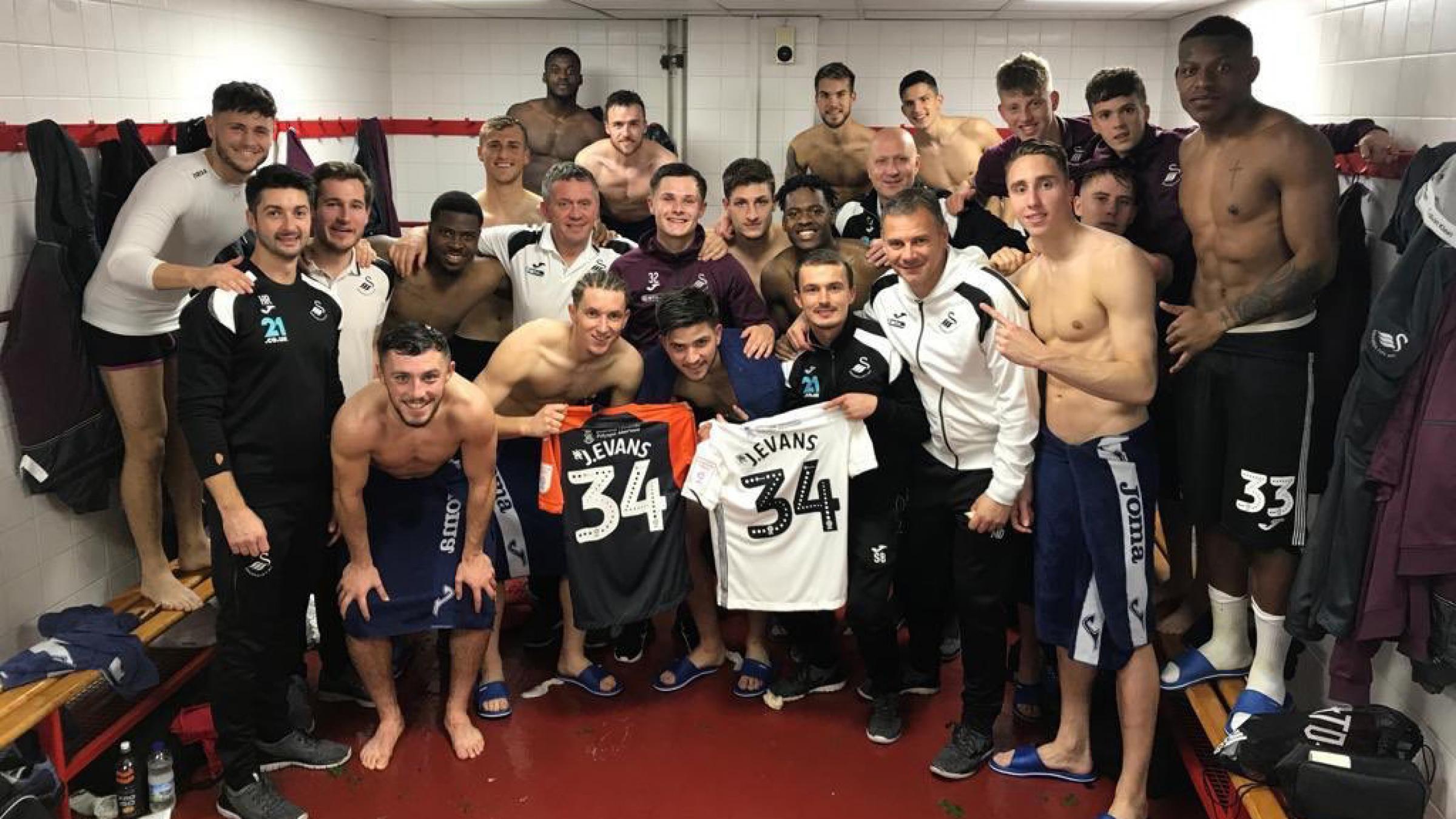 The Swans Under-23s team show their support to team-mate Jack Evans.