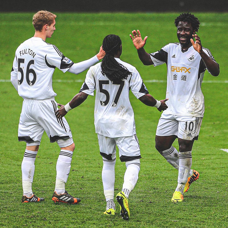 Photograph of Jay Fulton celebrating with Wilfried Bony and Marvin Emnes