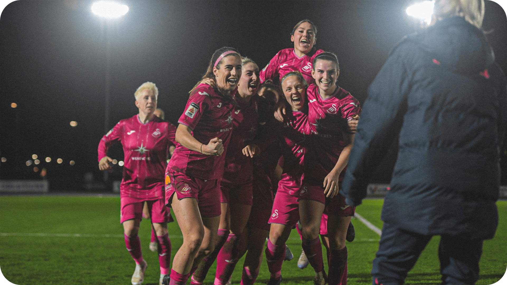 Photograph of the Women's team celebrating.