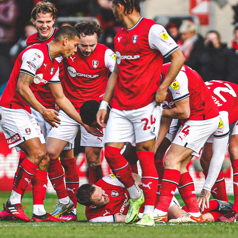 Rotherham squad celebrating scoring a goal