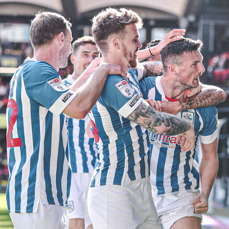 Huddersfield squad celebrating scoring at the Vicarage Road