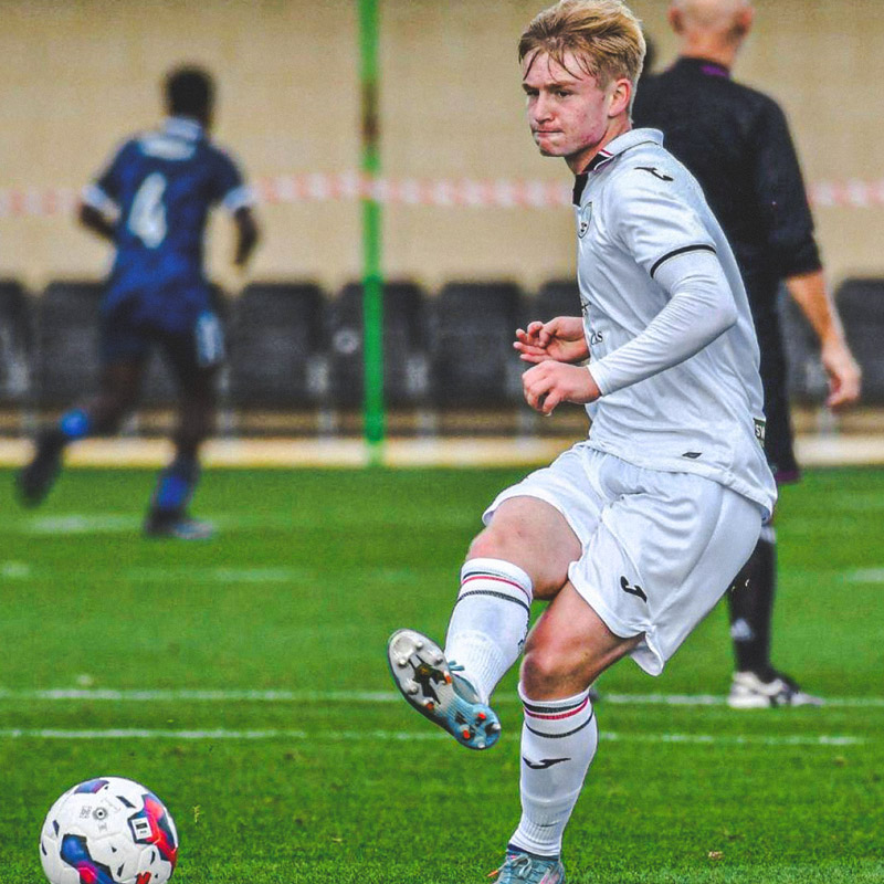 Swansea, Wales. 4 February 2023. Iwan Morgan of Swansea City high fives  Aimar Govea of Swansea City during the Professional Development League game  between Swansea City Under 18 and Millwall Under 18