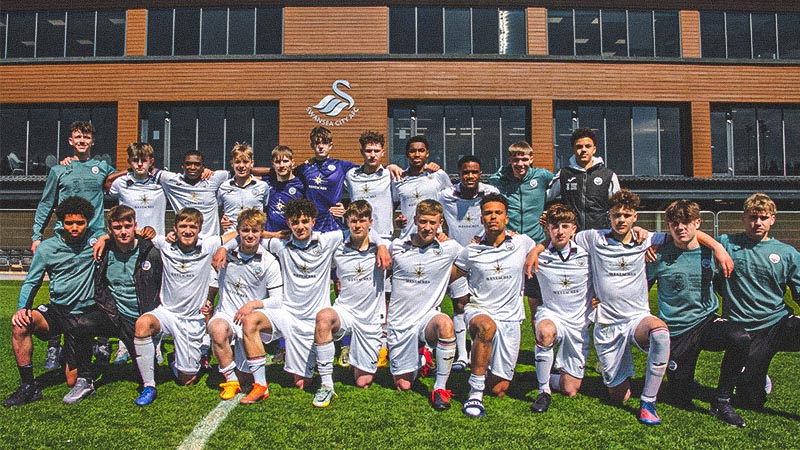 Swansea, Wales. 4 February 2023. Iwan Morgan of Swansea City high fives  Aimar Govea of Swansea City during the Professional Development League game  between Swansea City Under 18 and Millwall Under 18