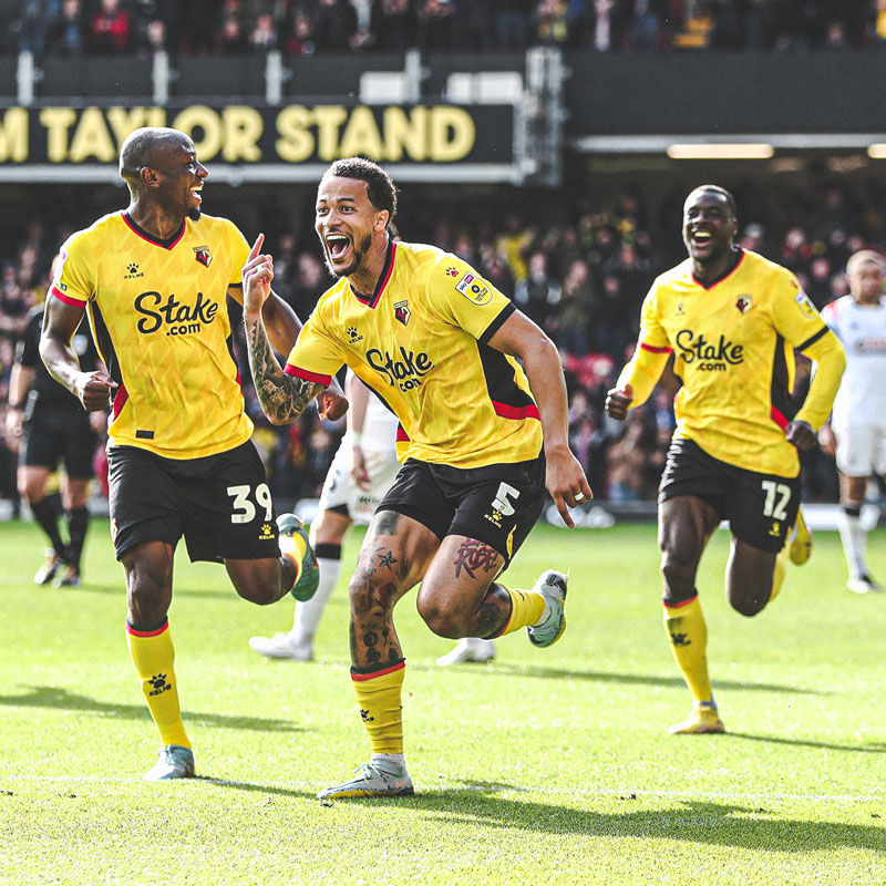 Watford squad celebrating scoring at the Vicarage Road Stadium.