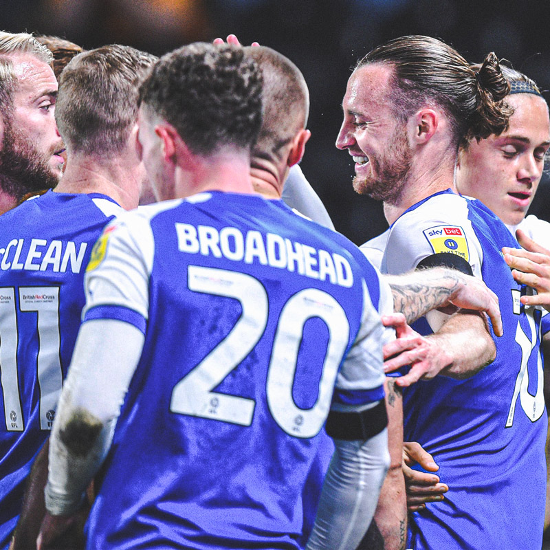 Wigan squad celebrating scoring