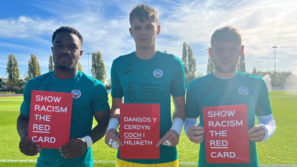 Geoff Bony, Ben Hughes and Josh Thomas hold show racism the red card cards