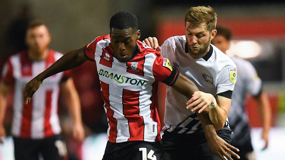Jordon Garrick battles for the ball at Lincoln City