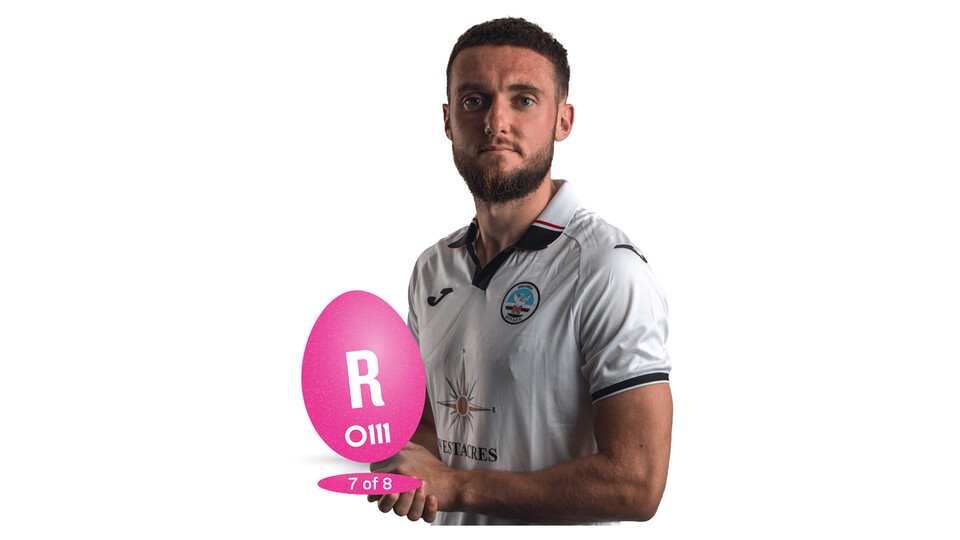 Matt Grimes holding an Easter Egg with "R"