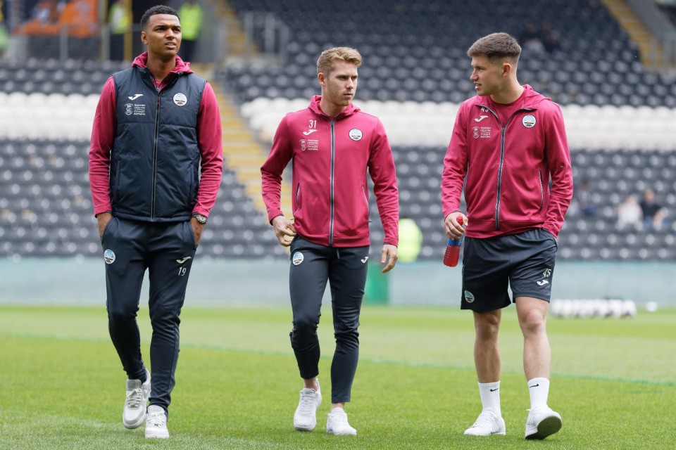 Whittaker, Cooper and Congreve walk on the pitch at the MKM Stadium 