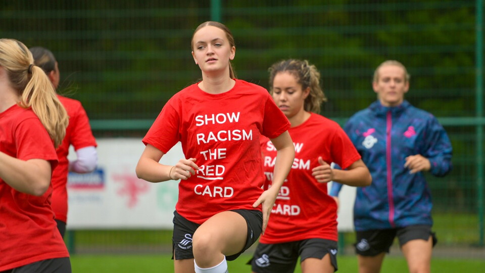 Swans women warm up in t-shirts supporting for Show Racism the Red Card