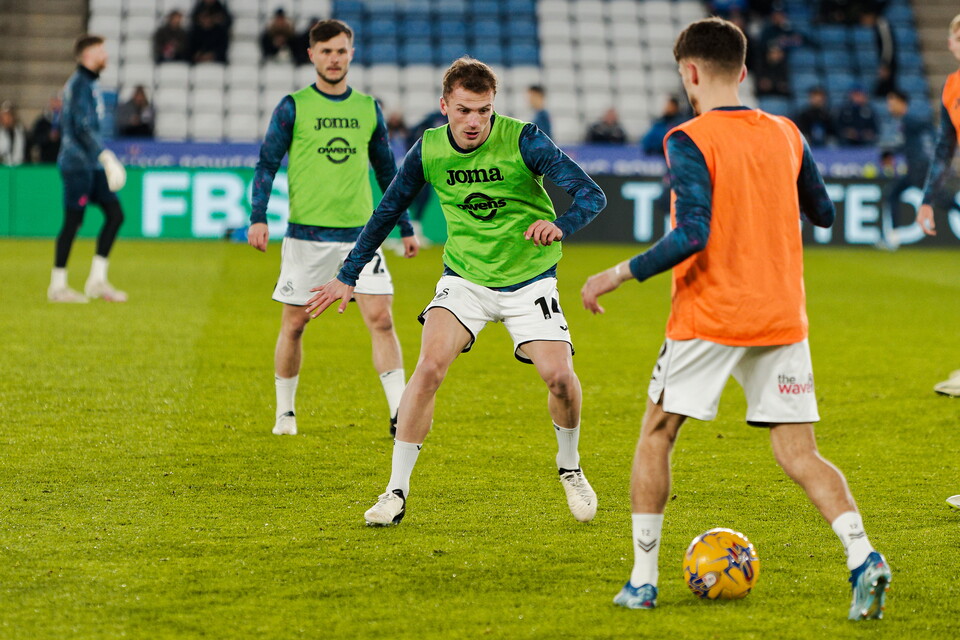 Players warm up before Leicester City