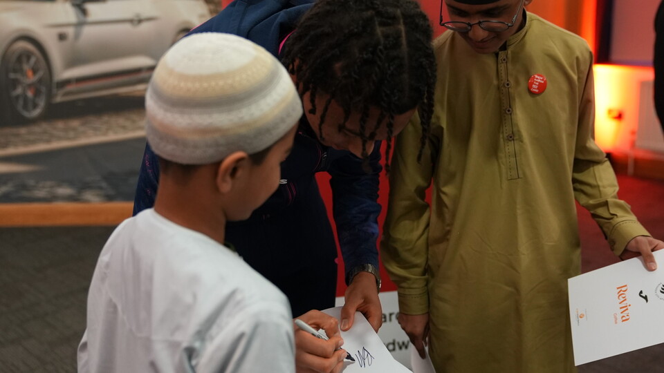 Bashir Humphreys signs autographs