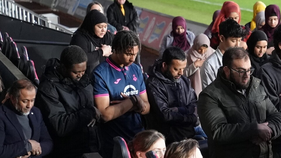 Bashir Humphreys joining in pitch side prayers