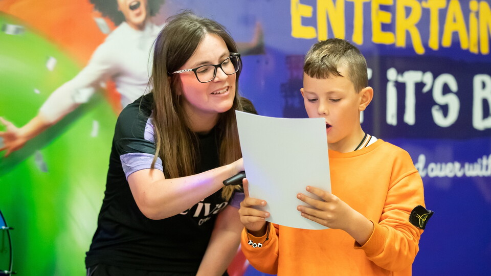 Young fan reading out team news