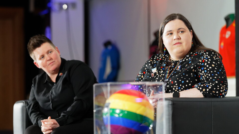 Carys and one other panelist sitting on a sofa at the Proud Together event