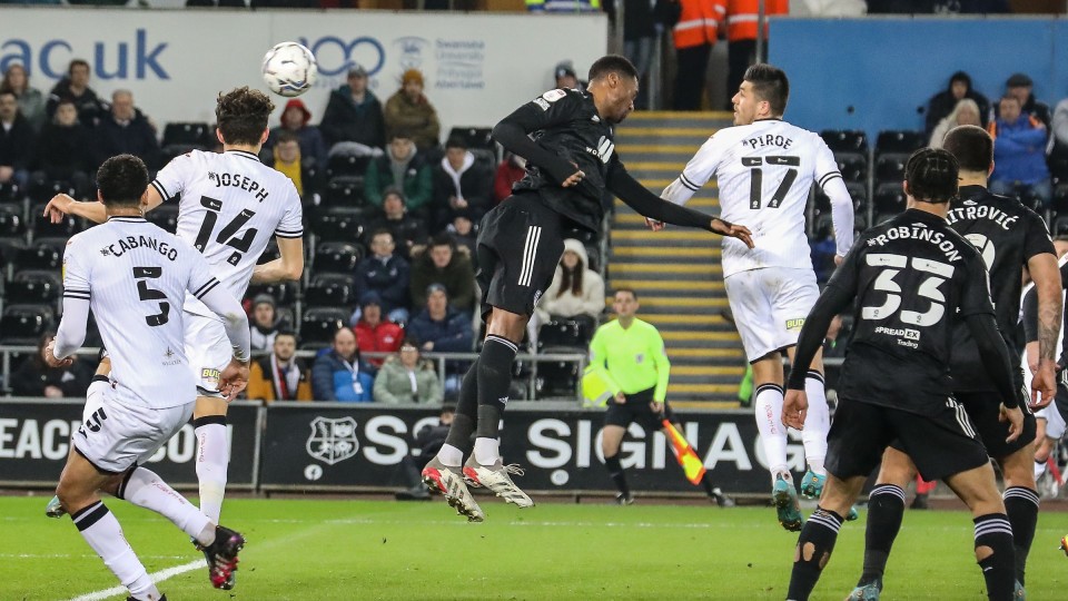 Joel Piroe scores a header against Fulham