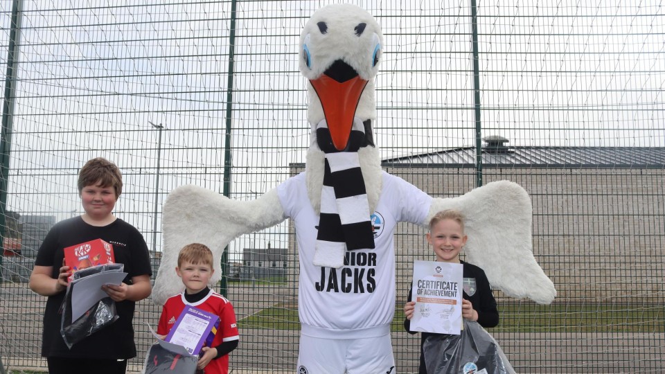 Cyril the Swan with kids on soccer camps