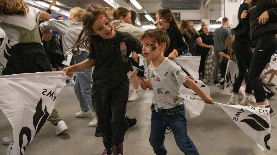 Two young fans dance during Swans game