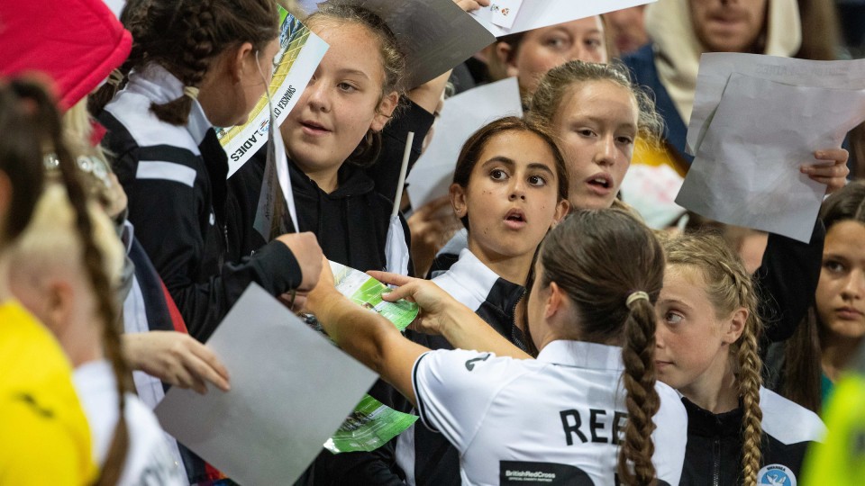 Swansea City Ladies players signing autographs
