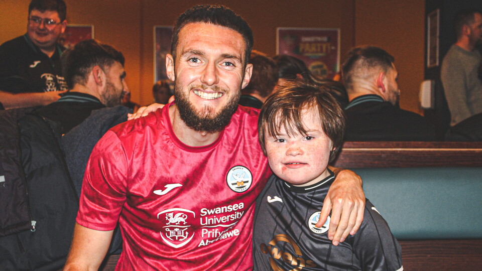Matt Grimes poses with young Swansea City fan