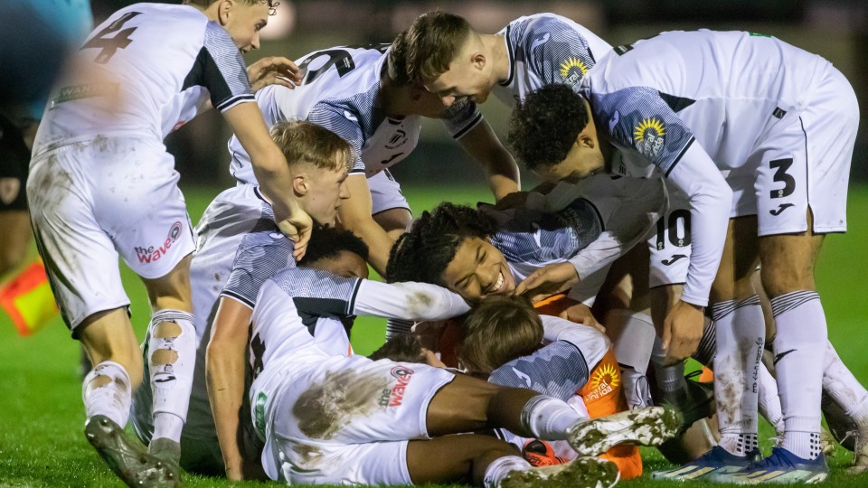 Under-21s celebrate with Remy Mitchell after his two saves send them to the final