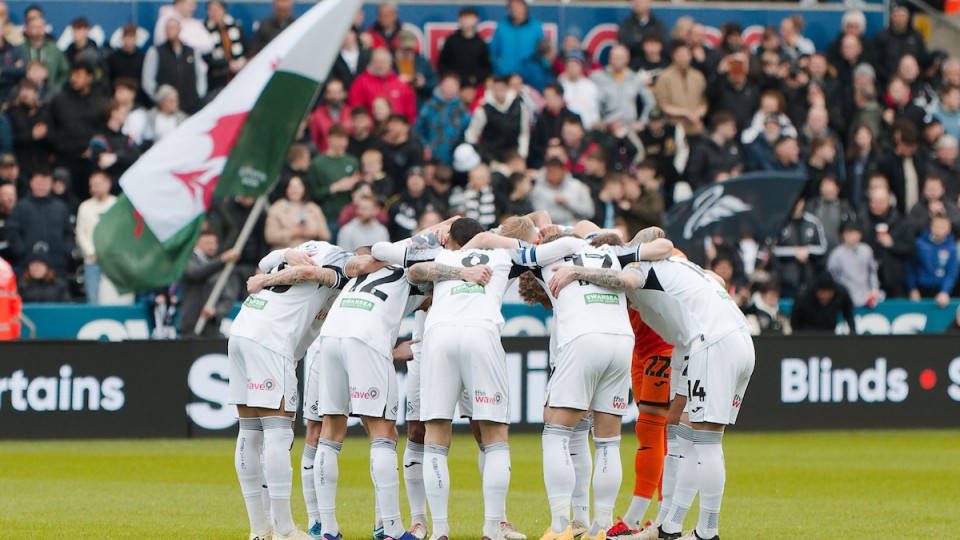 Swansea City players in a pre-match huddle