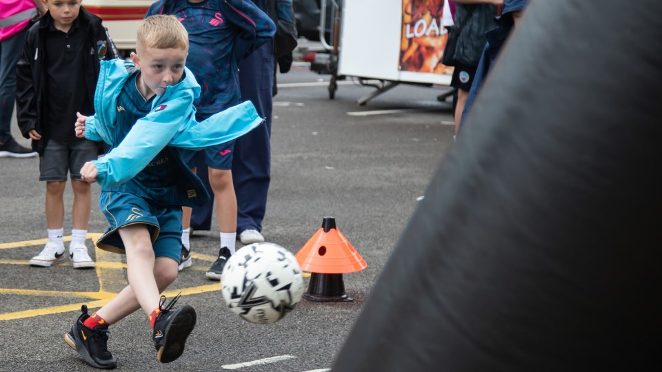 Junior Jack kicks a football 