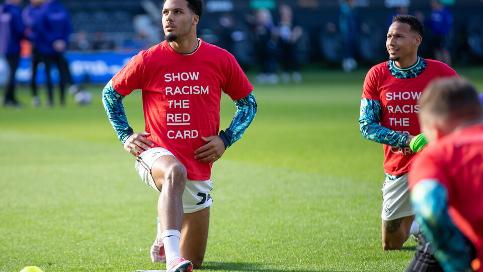 Players warm up in Show Racism the Red Card shirts