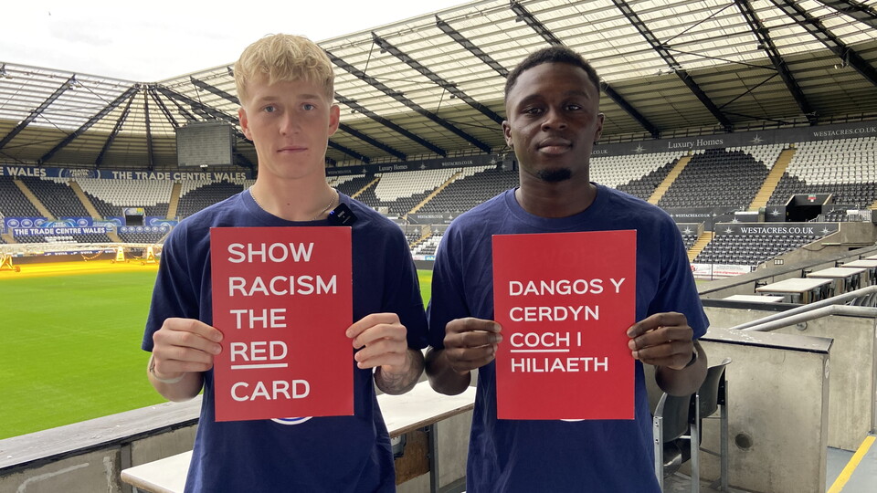 Widell and Inoussa hold Show Racism the Red Card cards