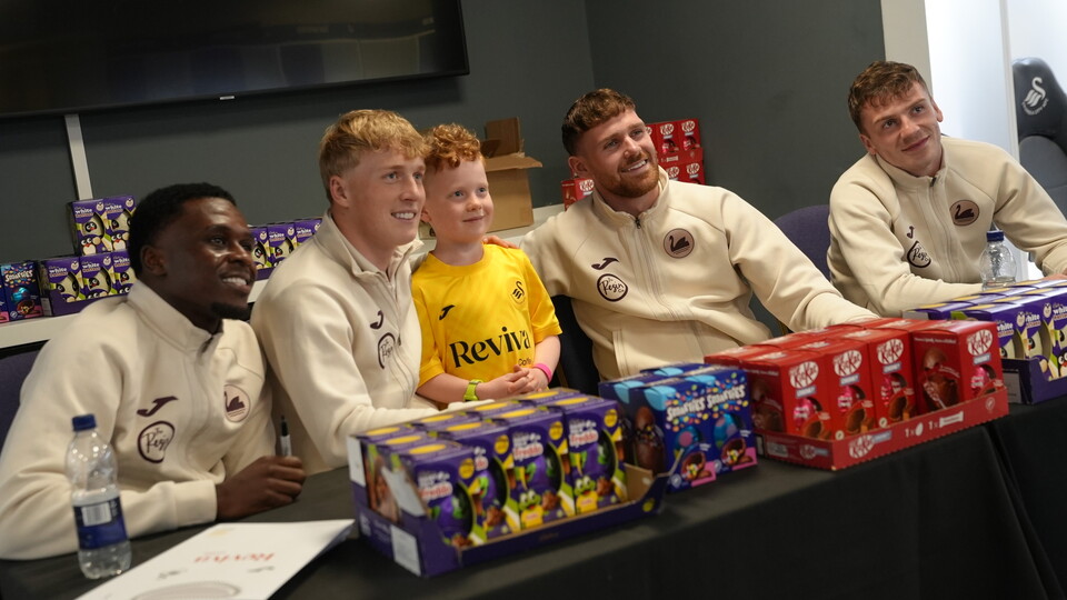 Players pose with a fan after the easter egg hunt.