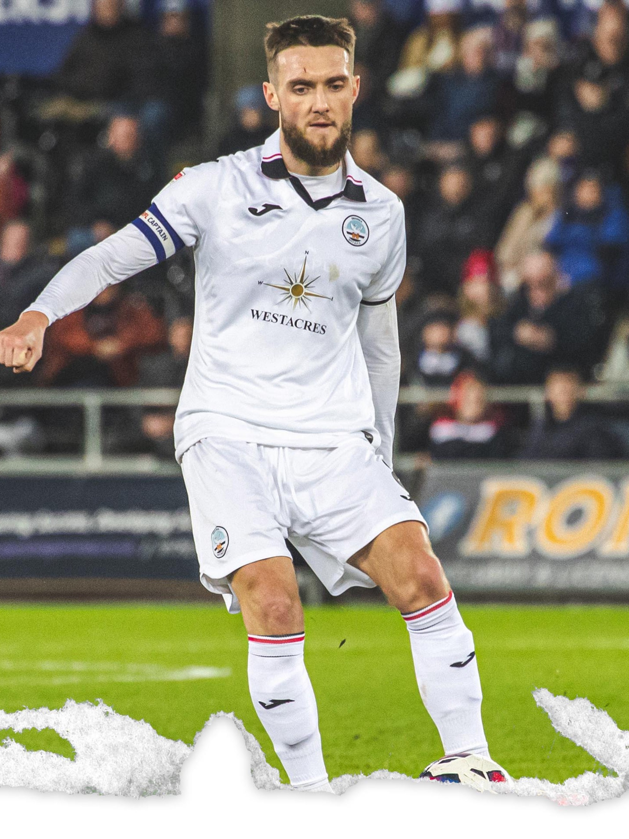 Photo of Matt Grimes controlling the ball