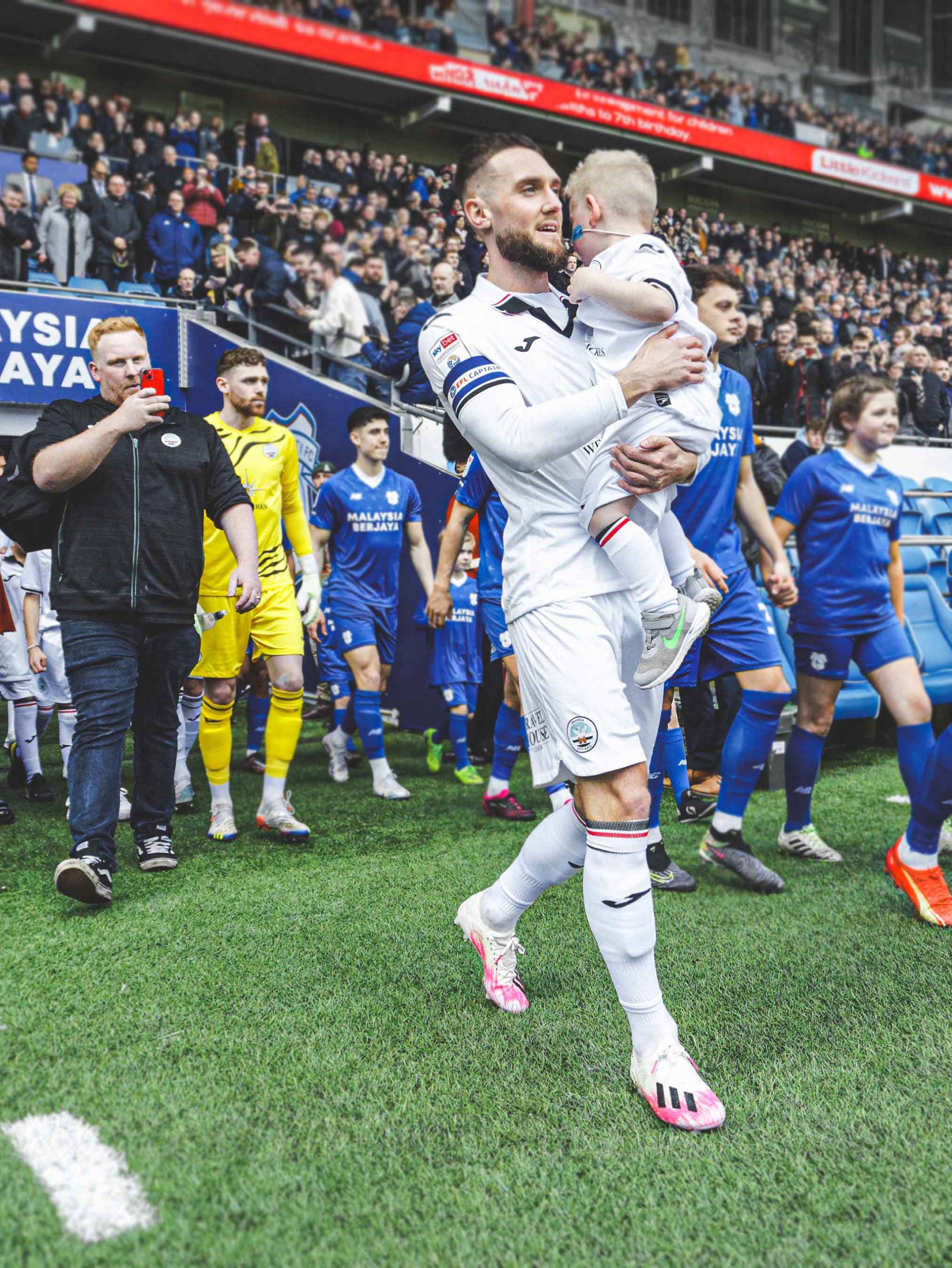 Morgan Ridler as Swansea City Mascot at Cardiff City Stadium, with Matt Grimes